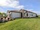 A well-manicured lawn surrounds this home's exterior at 10973 Trevino St, Englewood, FL 34223