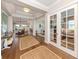 Spacious foyer showcasing hardwood floors and access to living spaces at 10973 Trevino St, Englewood, FL 34223
