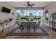 Covered lanai showcasing a dining table, a view of the pool, and outdoor charm, perfect for entertaining at 10973 Trevino St, Englewood, FL 34223