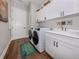 Functional laundry room boasting modern appliances, ample cabinet space, and stylish decor, making chores a breeze at 10973 Trevino St, Englewood, FL 34223