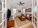 Inviting living room with a comfortable leather couch and large windows at 10973 Trevino St, Englewood, FL 34223