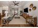 Spacious living room with a ceiling fan, hardwood floors, and a neutral color palette, perfect for relaxing and entertaining at 10973 Trevino St, Englewood, FL 34223