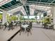 Covered outdoor seating area with views of the lush landscaping and golf course at 10973 Trevino St, Englewood, FL 34223