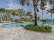 Inviting community pool surrounded by lush tropical landscaping and comfortable lounge seating at 10973 Trevino St, Englewood, FL 34223