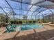 Beautiful screened-in pool surrounded by comfortable loungers, offering a serene and private outdoor oasis for relaxation at 10973 Trevino St, Englewood, FL 34223
