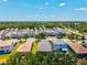 Aerial view showcasing a well-maintained residential neighborhood with neatly arranged homes and green spaces at 12478 Sagewood Dr, Venice, FL 34293