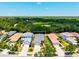 Aerial view of homes nestled among lush trees and landscaping in a quiet neighborhood at 12478 Sagewood Dr, Venice, FL 34293