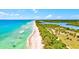 Beach community with a picturesque aerial view, highlighting the sandy shoreline and blue waters at 12478 Sagewood Dr, Venice, FL 34293