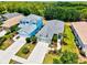 Aerial shot shows a neighborhood with lush greenery and well-maintained homes with tidy landscaping at 12478 Sagewood Dr, Venice, FL 34293