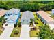 Aerial view showcases a well-kept neighborhood with trees, landscaping, and stylish homes at 12478 Sagewood Dr, Venice, FL 34293
