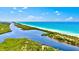 Serene aerial view of the beach, showcasing waterfront living and natural beauty at 12478 Sagewood Dr, Venice, FL 34293