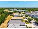 Wide aerial shot of the neighborhood, with various home styles and surrounding natural greenery at 12478 Sagewood Dr, Venice, FL 34293