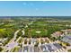 Wide angle aerial view showing the home's location within a sprawling residential community and green spaces at 12478 Sagewood Dr, Venice, FL 34293
