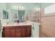 Bright bathroom featuring double vanity, large mirror, and walk-in shower at 12478 Sagewood Dr, Venice, FL 34293