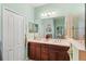 Bright bathroom featuring double vanity, large mirror, and separate shower at 12478 Sagewood Dr, Venice, FL 34293