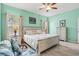 Comfortable bedroom with calming green walls, windows with great natural light, and light-colored furniture at 12478 Sagewood Dr, Venice, FL 34293