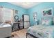 Bedroom with light laminate flooring, twin bed, and bright natural light at 12478 Sagewood Dr, Venice, FL 34293
