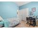 Bright bedroom featuring a twin bed, light laminate flooring, and two closets at 12478 Sagewood Dr, Venice, FL 34293