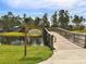 Scenic bridge leading to Lookout Point Island surrounded by water and trees at 12478 Sagewood Dr, Venice, FL 34293