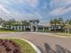 Stunning community clubhouse with stone accents, lush landscaping and circular driveway at 12478 Sagewood Dr, Venice, FL 34293