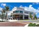 Exterior of a modern Foxtail Coffee building featuring large windows and a brick paved entrance at 12478 Sagewood Dr, Venice, FL 34293