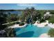 An inviting community pool and slide surrounded by lush landscaping, perfect for recreation at 12478 Sagewood Dr, Venice, FL 34293