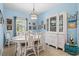 Bright dining room featuring a white table, china cabinet, and natural light, ideal for elegant dinners at 12478 Sagewood Dr, Venice, FL 34293