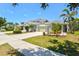 Charming single-story home with a well-manicured lawn, beautiful landscaping, and a welcoming curb appeal at 12478 Sagewood Dr, Venice, FL 34293