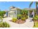 Beautiful single-story home with a well-manicured lawn and landscaping, along with a two-car garage at 12478 Sagewood Dr, Venice, FL 34293