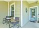 Cozy front porch features a comfortable seating area and charming decor, creating a welcoming entrance at 12478 Sagewood Dr, Venice, FL 34293
