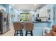 Open-concept kitchen with granite countertops, stainless steel appliances, and breakfast bar seating area at 12478 Sagewood Dr, Venice, FL 34293