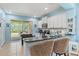 Beautiful kitchen featuring granite counters, white cabinets, tile floor and breakfast bar with seating at 12478 Sagewood Dr, Venice, FL 34293