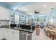 Open concept kitchen featuring granite counters, bright lighting and breakfast bar at 12478 Sagewood Dr, Venice, FL 34293