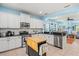 Spacious kitchen featuring modern appliances, granite counters, and a view into the living area at 12478 Sagewood Dr, Venice, FL 34293