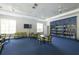 Community library with bookshelves full of books, tables and comfortable seating at 12478 Sagewood Dr, Venice, FL 34293