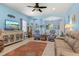 Inviting living area with comfortable seating, a ceiling fan, and seamless flow into the dining space for gatherings at 12478 Sagewood Dr, Venice, FL 34293