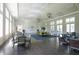 Large meeting room with hard wood floors, tall windows and stylish decor at 12478 Sagewood Dr, Venice, FL 34293