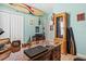 Office with light wood flooring, a wood desk, and a closet with a surfboard on top at 12478 Sagewood Dr, Venice, FL 34293