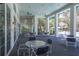 Covered outdoor patio featuring brick floors and seating with views of trees at 12478 Sagewood Dr, Venice, FL 34293