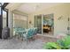 The screened patio shows room for a grill, a ceiling fan, and sliding glass doors to the interior at 12478 Sagewood Dr, Venice, FL 34293