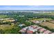 An aerial view of the community with mature trees and convenient access to nearby amenities at 129 Preserve Pl # D, Nokomis, FL 34275