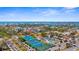 Beautiful aerial view of tennis courts, and nearby cityscape with ocean in distance, under a partly cloudy blue sky at 129 Preserve Pl # D, Nokomis, FL 34275
