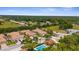 Aerial view of the community showcasing the well-maintained homes, landscaping, and community pool at Pinebrook Preserve at 129 Preserve Pl # D, Nokomis, FL 34275