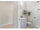 Bathroom showcasing a toilet, vanity, and towel rack, offering essential amenities in a compact space at 129 Preserve Pl # D, Nokomis, FL 34275