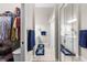 Bathroom with double sinks, mirrored closets, and neutral tiles, offering functionality and style at 129 Preserve Pl # D, Nokomis, FL 34275