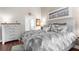 Well-lit bedroom with artwork, hardwood floors and neutral decor for a soothing and restful ambiance at 129 Preserve Pl # D, Nokomis, FL 34275