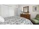 Cozy bedroom featuring rattan furniture, plantation shutters, and a closet, offering a tranquil and stylish retreat at 129 Preserve Pl # D, Nokomis, FL 34275