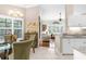 Cozy dining area showcases a glass table with seating for four, seamlessly connected to the living room at 129 Preserve Pl # D, Nokomis, FL 34275