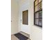 Elegant front door with decorative glass insert and sleek hardware providing a warm welcome to the home at 129 Preserve Pl # D, Nokomis, FL 34275