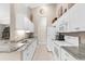 Modern kitchen with white cabinets, granite countertops, and stainless steel appliances at 129 Preserve Pl # D, Nokomis, FL 34275